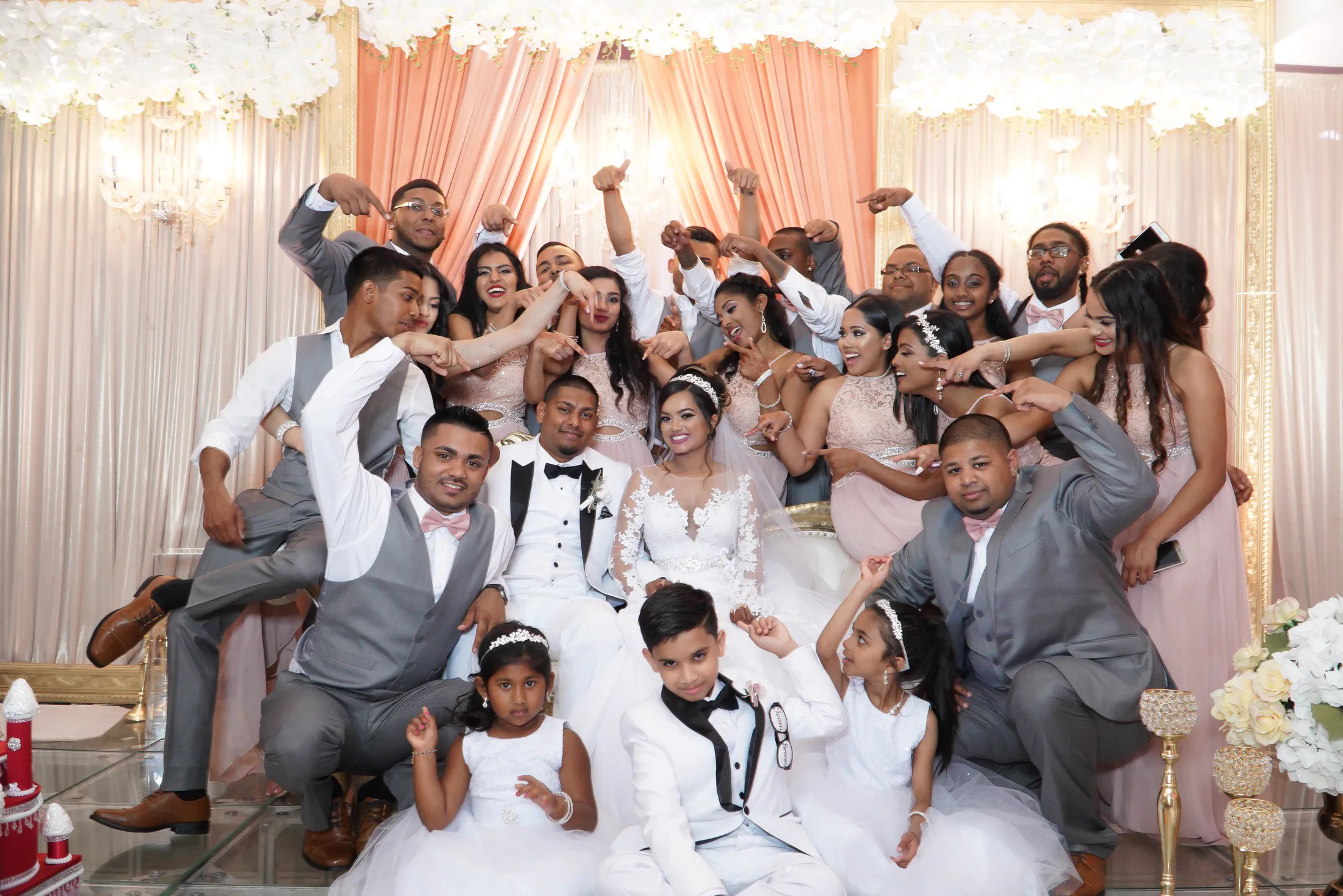 A wedding party celebrates together around the newlyweds.