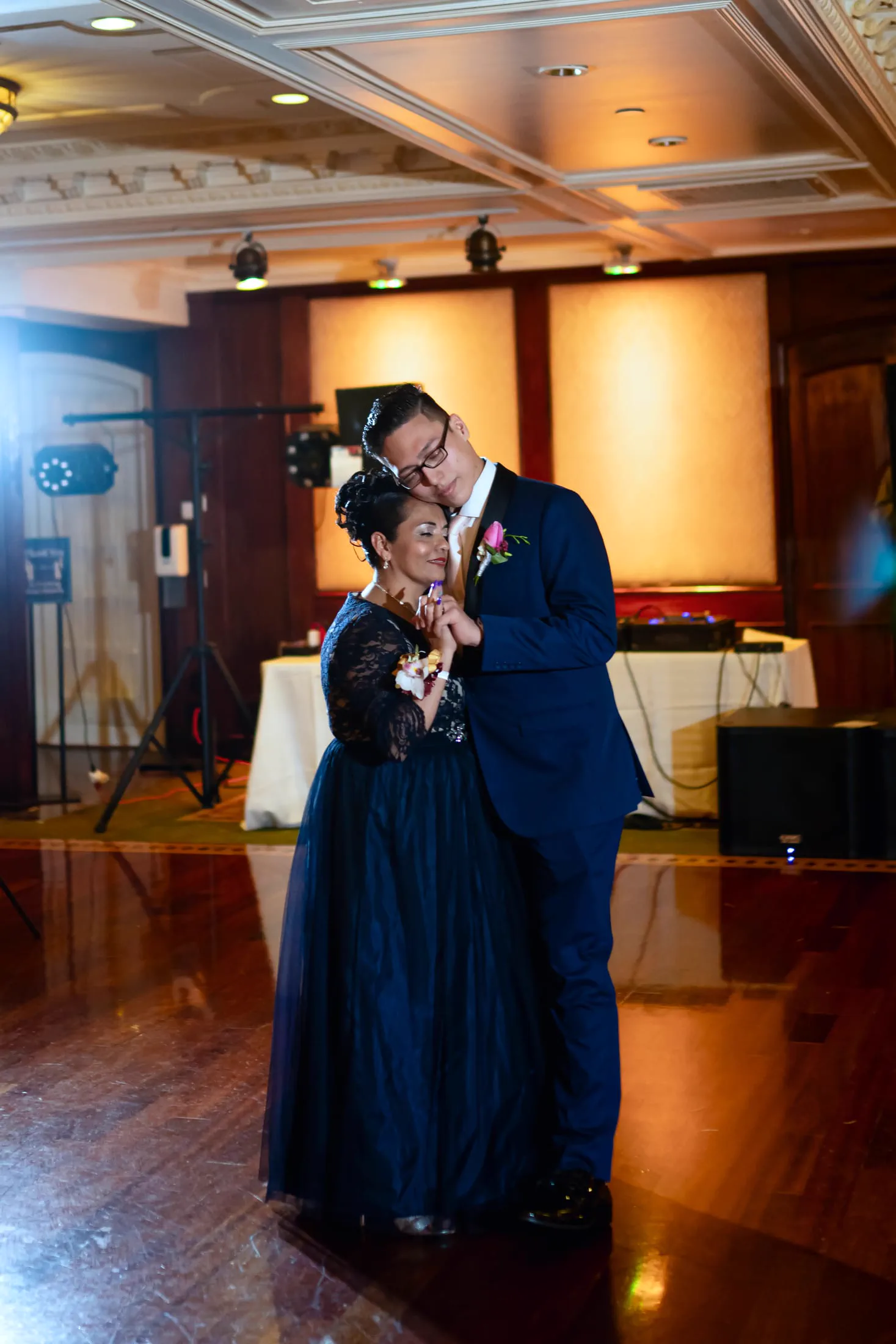 A couple shares a tender slow dance at the reception.
